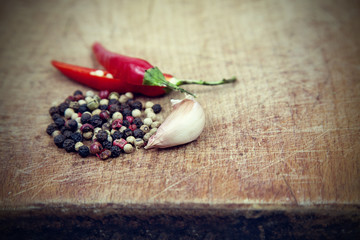 sRed hot chili peppers with spice ingredient on wood