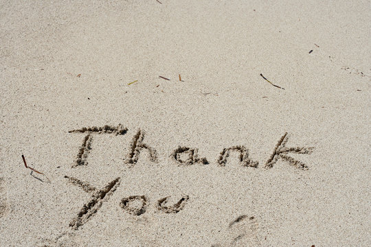 Thank you handwritten in sand for natural, symbol,tourism