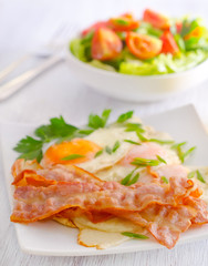 Breakfast, bakon with salad and eggs