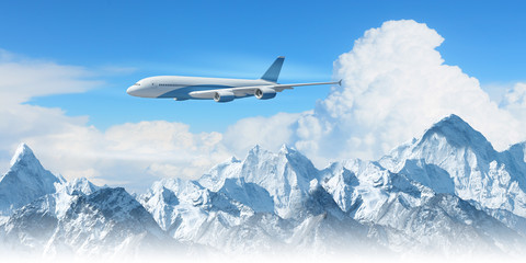 Fototapeta premium White passenger plane above the mountains