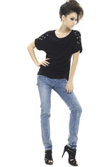 Full length casual young woman in blue jeans posing