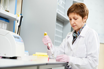 scientist with Dropper at laboratory