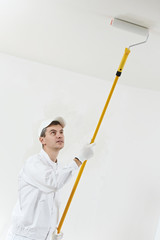 house painter at work with painting roller