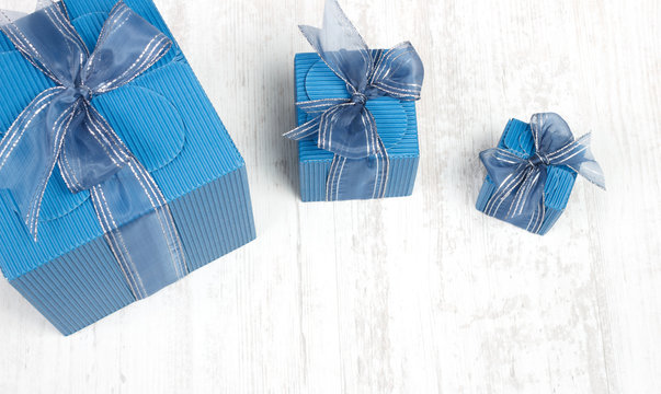 Three blue carton gift boxes