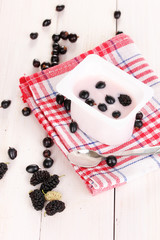 Yogurt with berries on wooden background