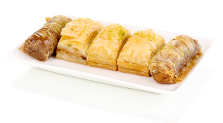 Sweet baklava on plate isolated on white