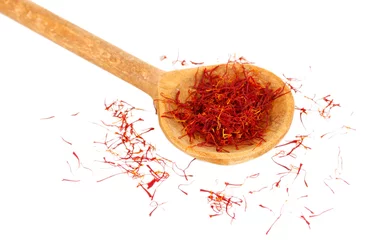 Wall murals Herbs 2 stigmas of saffron in wooden spoon on white background close-up