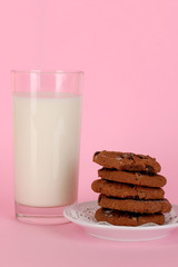 Glass of fresh new milk on pink background