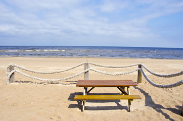 summer sea beach with ropes fence