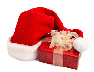 Obraz na płótnie Canvas Santa hat and gift box on a white