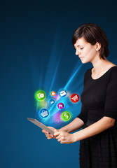 Young woman looking at modern tablet with abstract lights and va