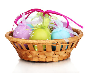 Colorful easter eggs in basket isolated on white