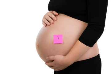 Pregnant woman holding her belly with pink sticker