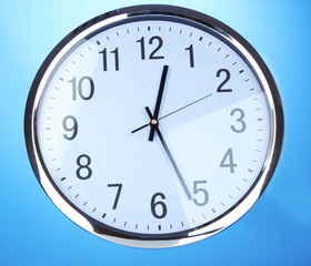 round office clock on blue background
