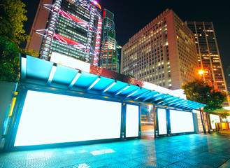 Blank billboard on bus stop at night
