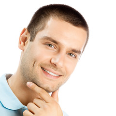 Obraz premium Cheerful thinking young man, over white