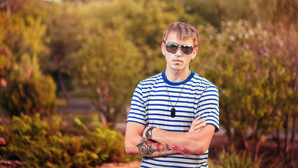 Portrait of young man wearing sunglasses outdoors