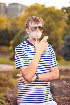 Man smoking a cigarette outside