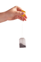 Woman hand with teabag isolated on white background
