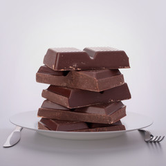 Chocolate bars stack on plate.