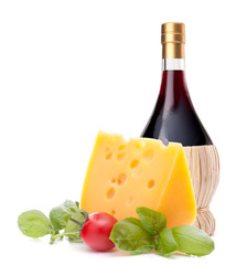 Red wine bottle, cheese and tomato still life