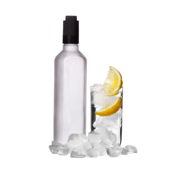 Bottle of vodka and wine glass with lemon and ice isolated on wh