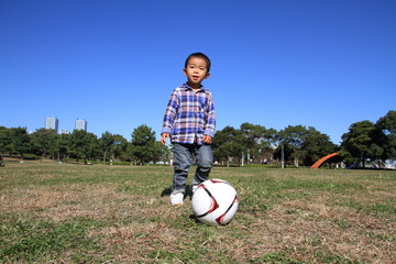 Fototapeta premium サッカーボールを蹴る幼児