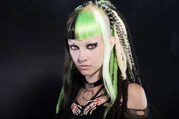 Fototapeta premium Cyber punk girl with green blond hair and red eyes against black