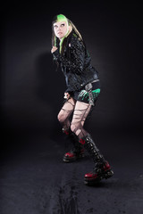 Cyber punk girl with green blond hair and red eyes against black