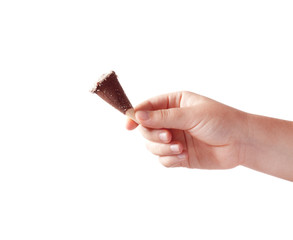 Human hand holding one sweet chocolate candy food