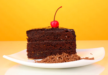 Chocolate cake on yellow background
