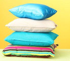 Colorful pillows on yellow background