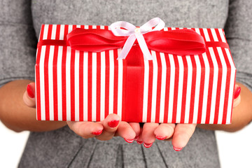 woman holds  box with gift on white background close-up
