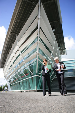Businesswomen standing in front of a building