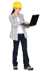 Woman in a hardhat with a laptop