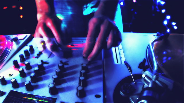 studio shoot of a cool male dj behind the turntables