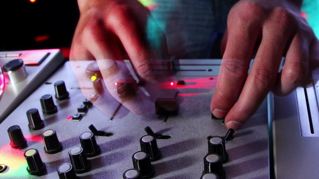 studio shoot of a cool male dj behind the turntables