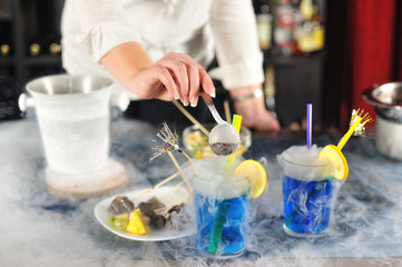 Lady bartender serving cocktails
