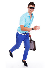 Portrait of handsome man posing on black background with bag