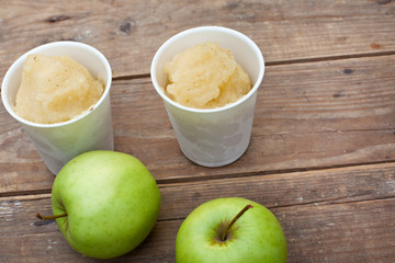 Apple sorbet and apples on wooden table