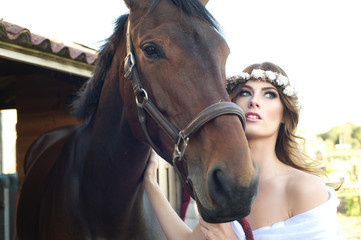 Fototapeta premium Beautiful Young Bride and her Brown Horse