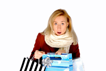 Beautiful excited isolated blonde girl opening Christmas present