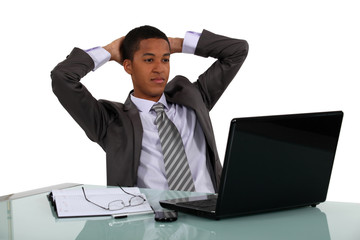 Businessman reclining back in his chair