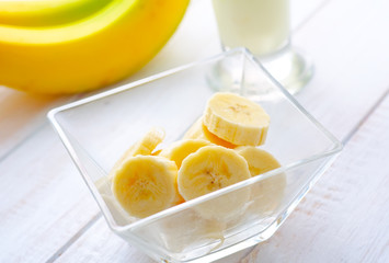 Fresh banana in the glass bowl, banana and milk