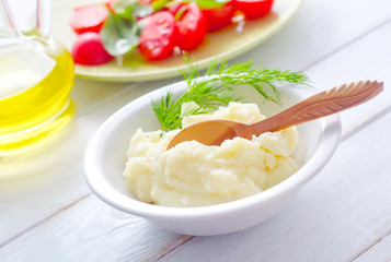 Mushed potato in the white bowl
