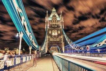 Detail of Tower Bridge in London at night with car light trail -