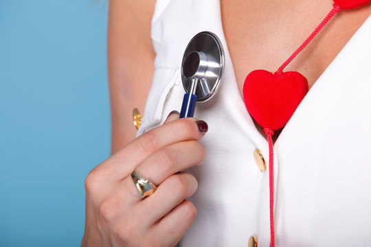 woman in nurse suit with stetoscope red heart