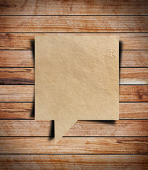 Paper speech bubble on wood background