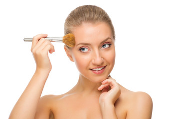 Young girl with makeup brush