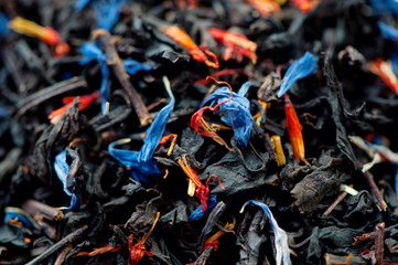 Black tea leaves and dried flowers, studio shot